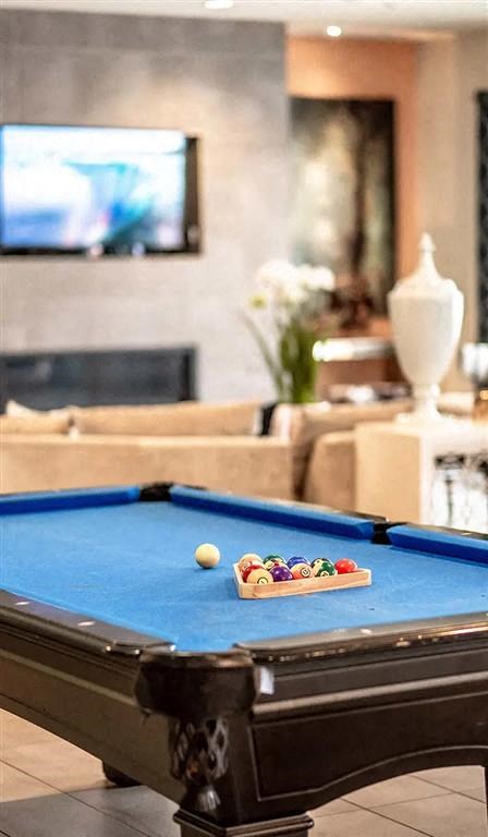 a pool table in a living room with a tv