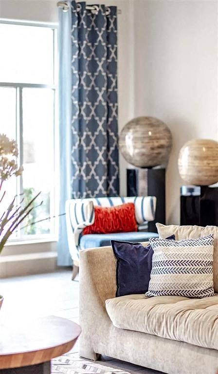 a living room with a couch with pillows on it