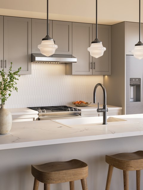 A kitchen with a white countertop and a sink under a window.