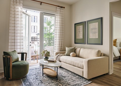 A living room with a couch, chair, and coffee table.
