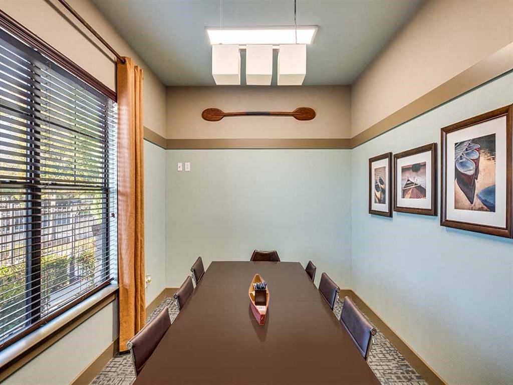 a dining room with a long table and chairs