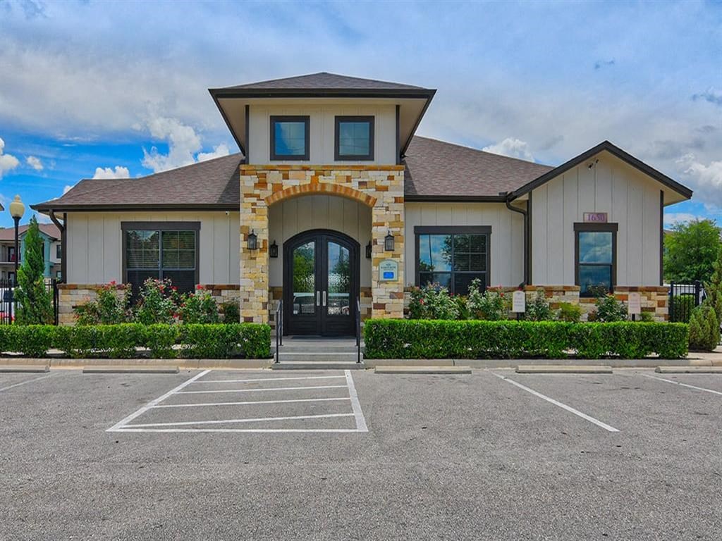 the front of a house with an empty parking lot