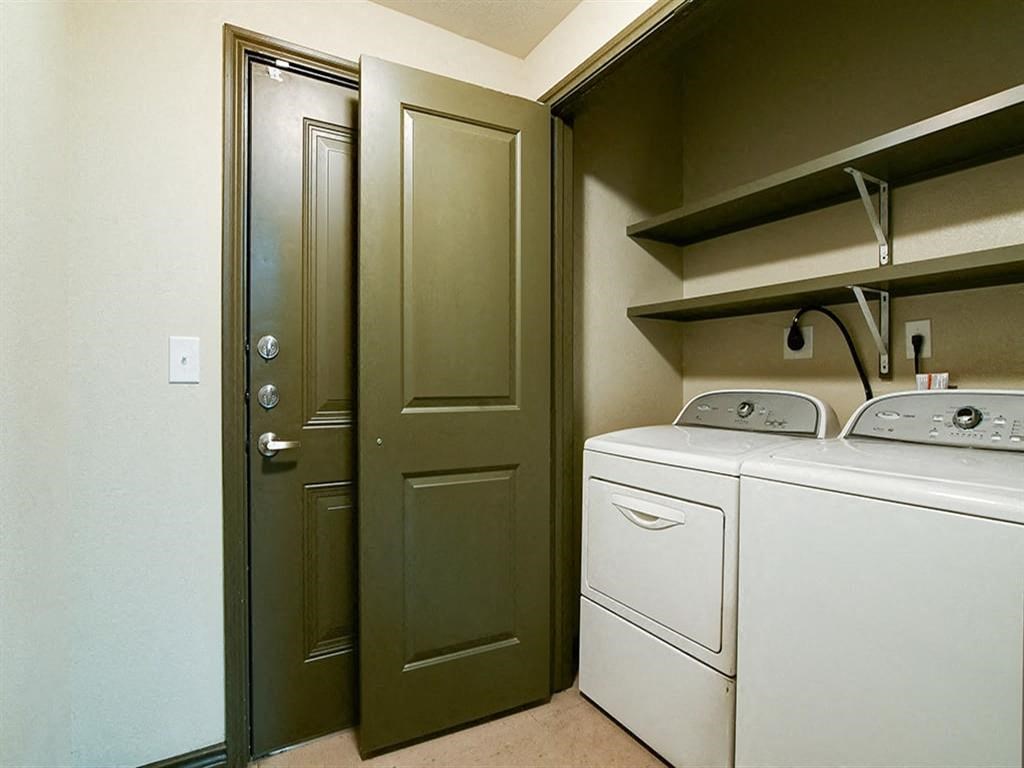 a white washer and dryer in a room with a closet