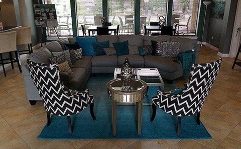 a living room with black and white chairs and a couch