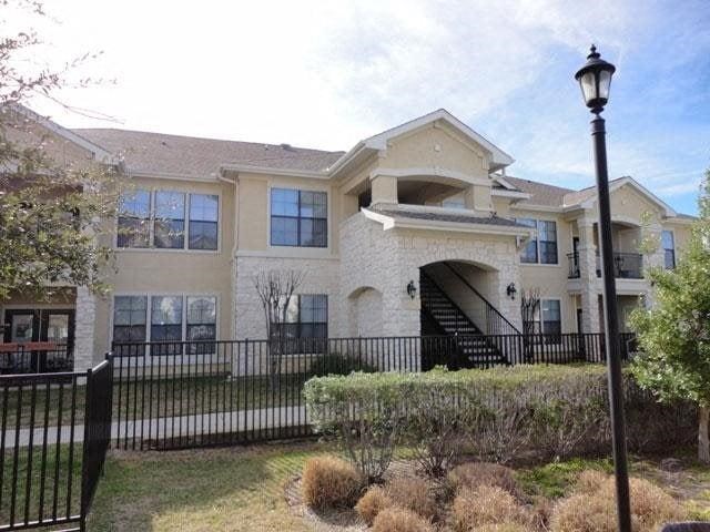 a large house with a black fence in front of it