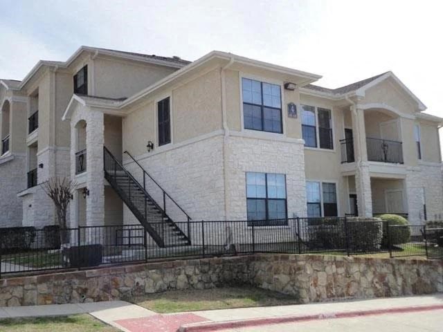 a large white house with a black fence