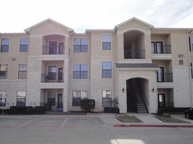 an apartment building with a staircase and a door
