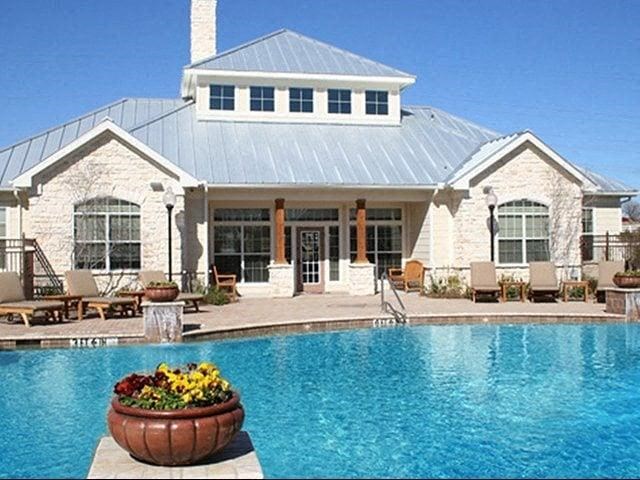 a large swimming pool in front of a house