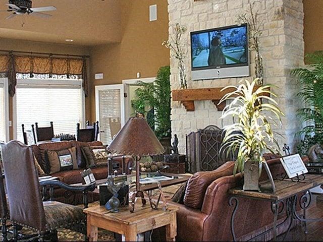 a living room with a fireplace and a tv on the wall
