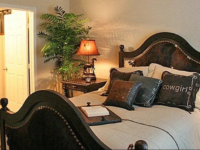 a bedroom with a bed with pillows and a lamp