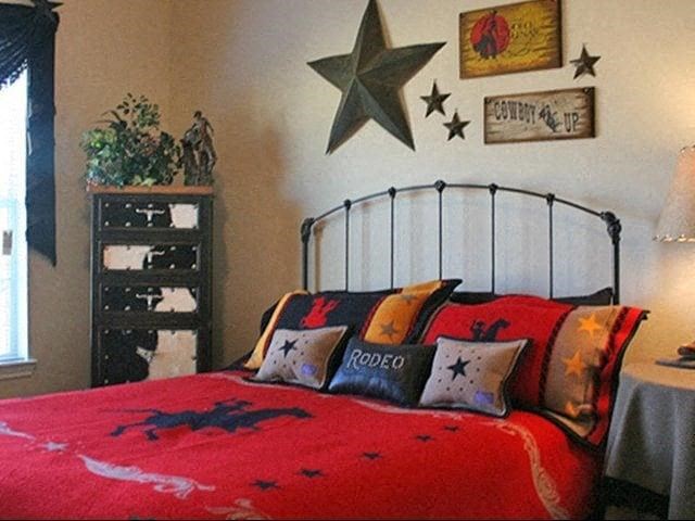 a bedroom with a red bed and stars on the wall