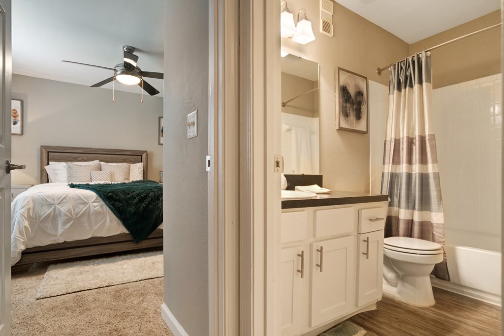 A bedroom with a bed, a toilet, and a shower.