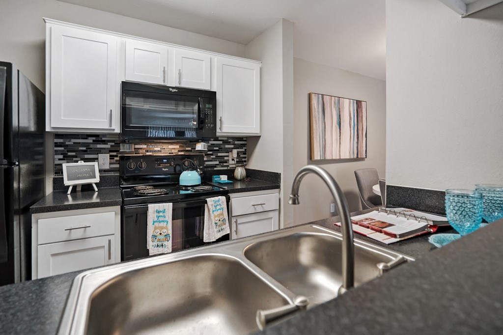 A kitchen with a stove, oven, and microwave.