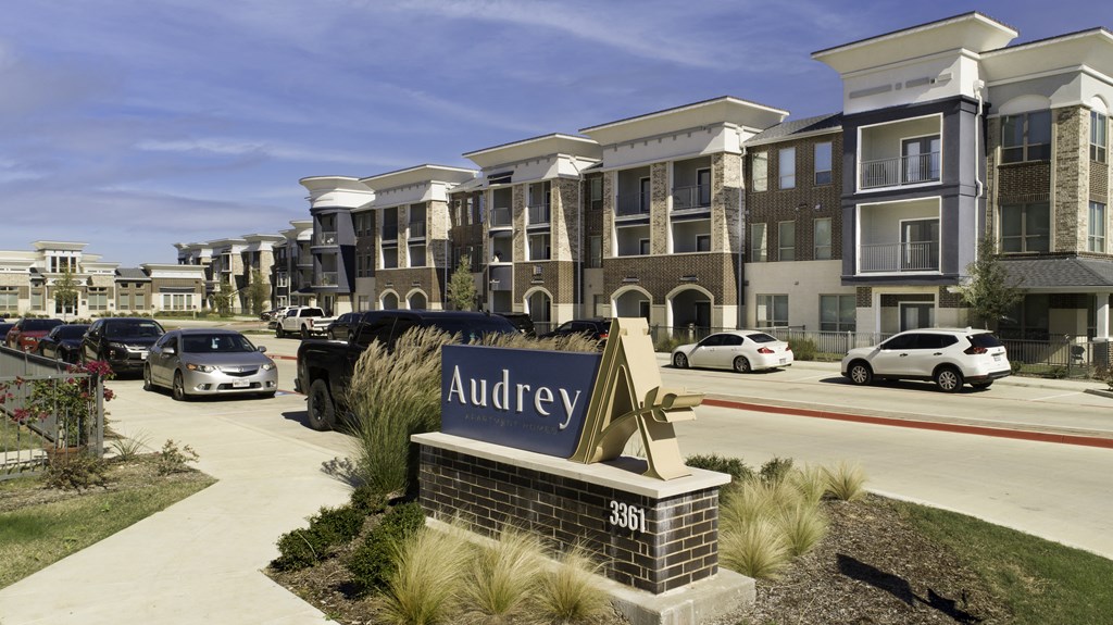 a sign in front of a parking lot