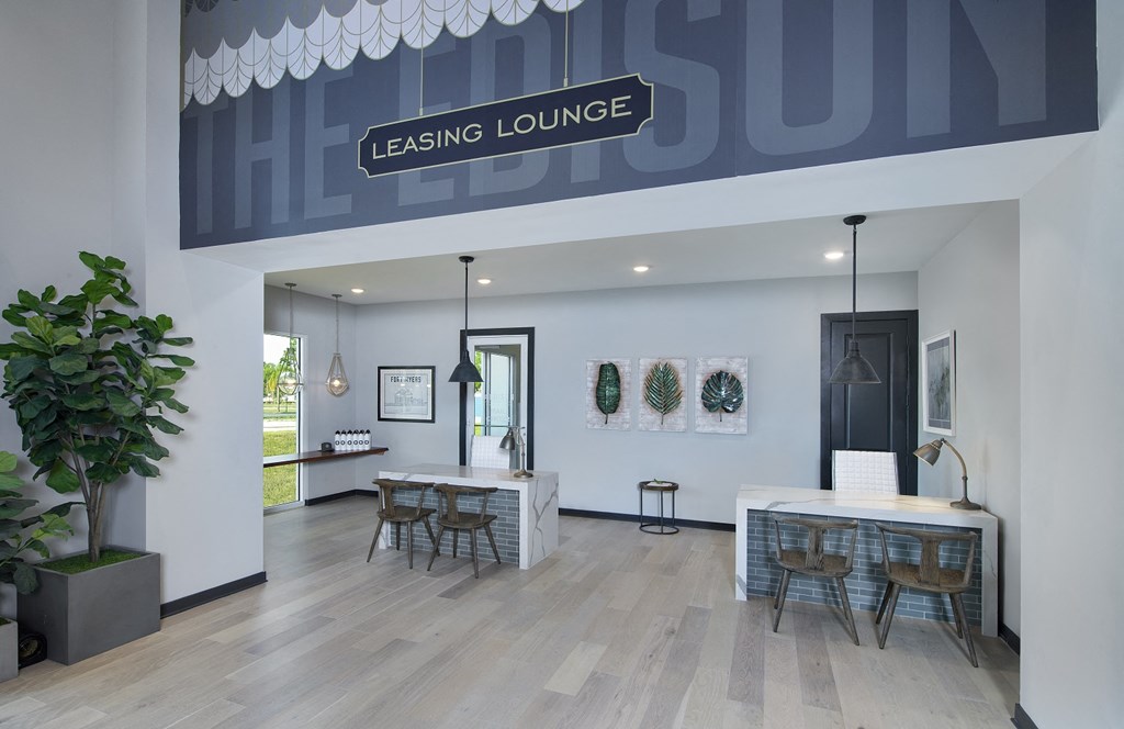 a rendering of the leasing lounge with a long table with chairs and a bar with stools