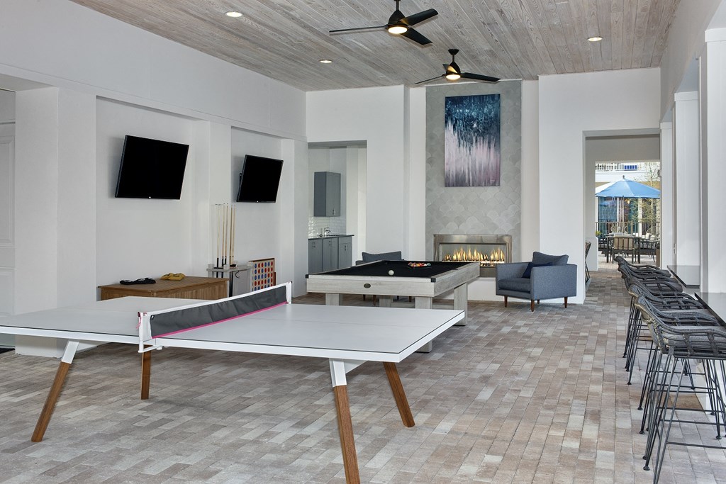 a games room with a ping pong table and a foosball table
