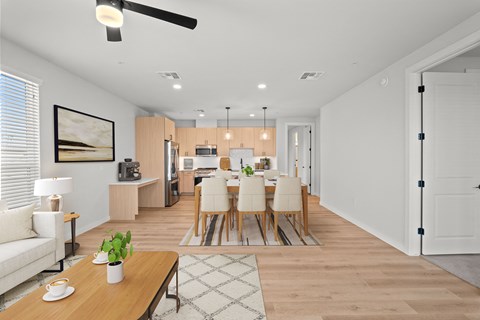 a living room and dining room with a table and chairs
