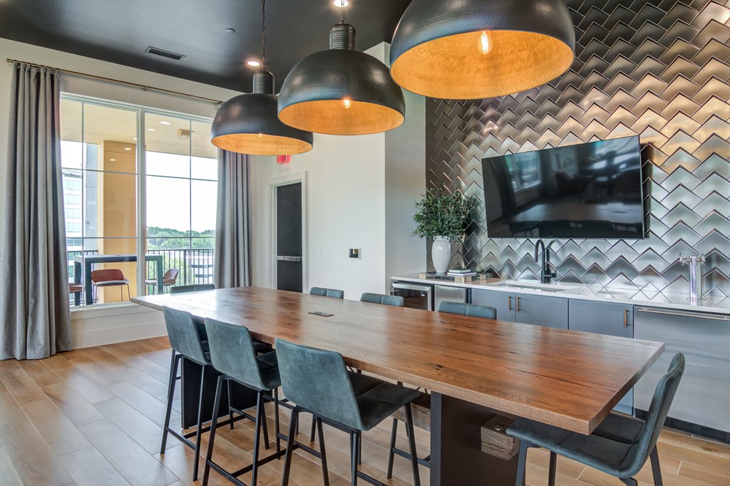 A modern dining room with a wooden table and chairs.