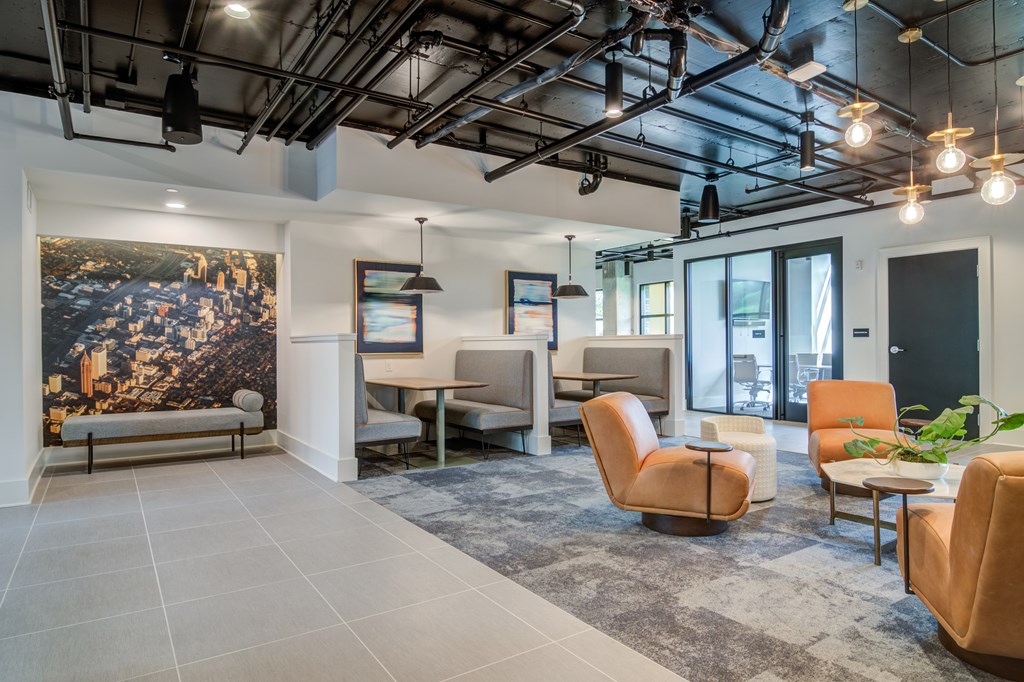 A modern office space with a large mural on the wall and comfortable seating.