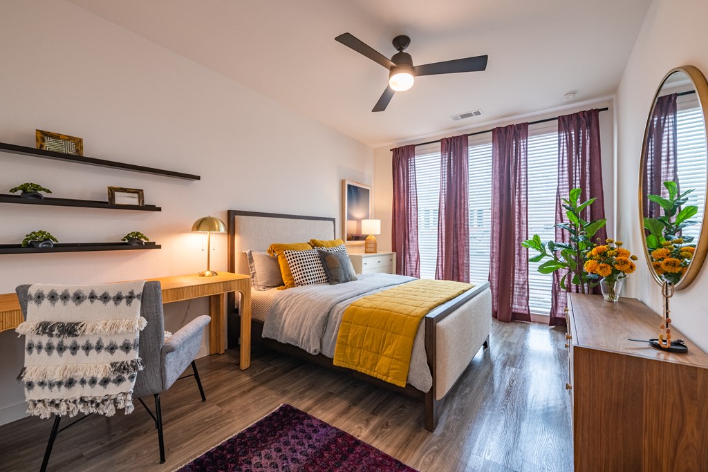 a bedroom with a bed and a desk with a chair