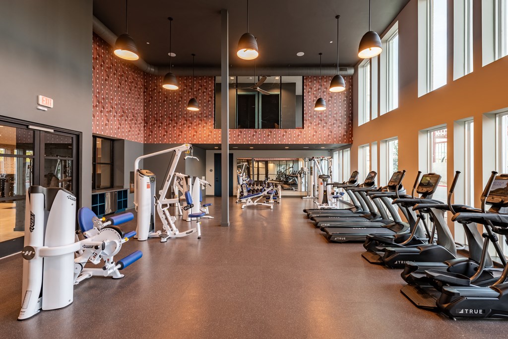 a large exercise room with treadmills and other exercise equipment