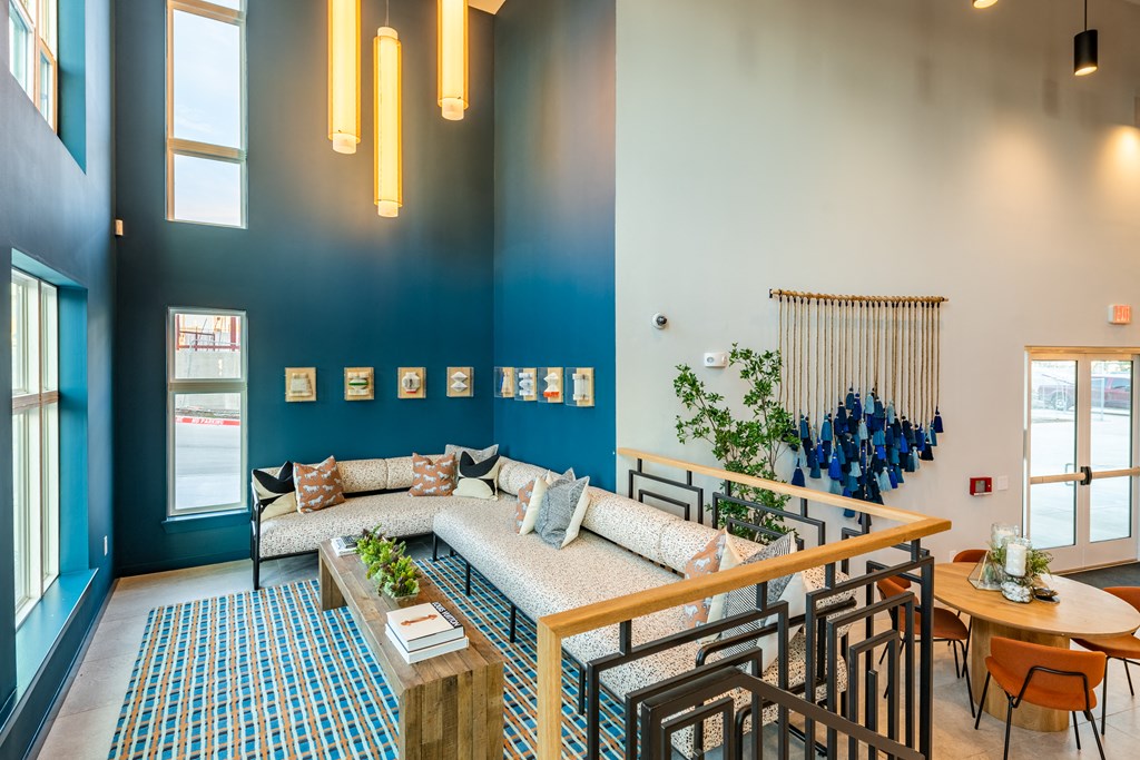 a living room with blue walls and a large couch