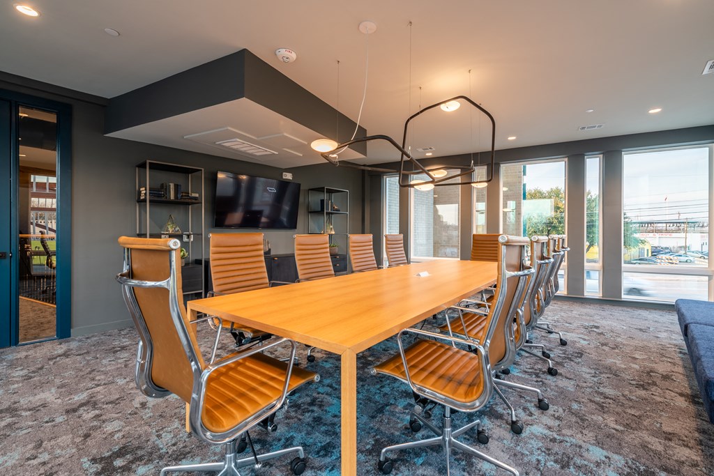 a conference room with a long wooden table and chairs