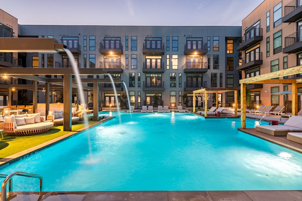 a swimming pool with a water slide in front of a building