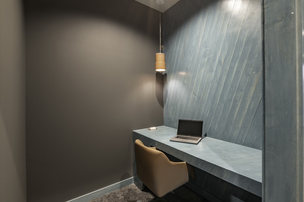 a small desk with a laptop on it