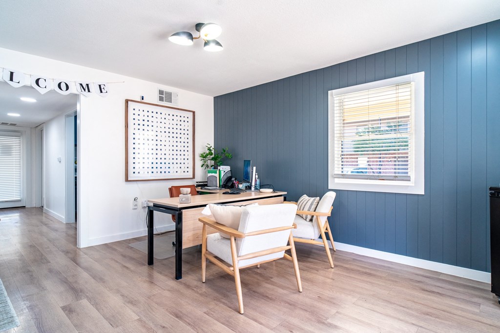 a dining room with a table and chairs and a window