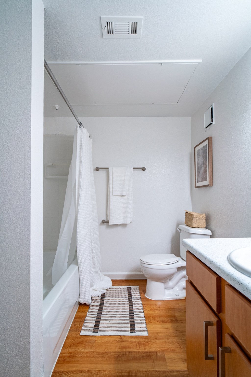 a bathroom with a toilet and a shower and a sink