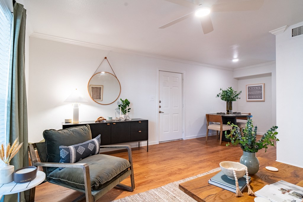 a living room with a couch and a table and a mirror