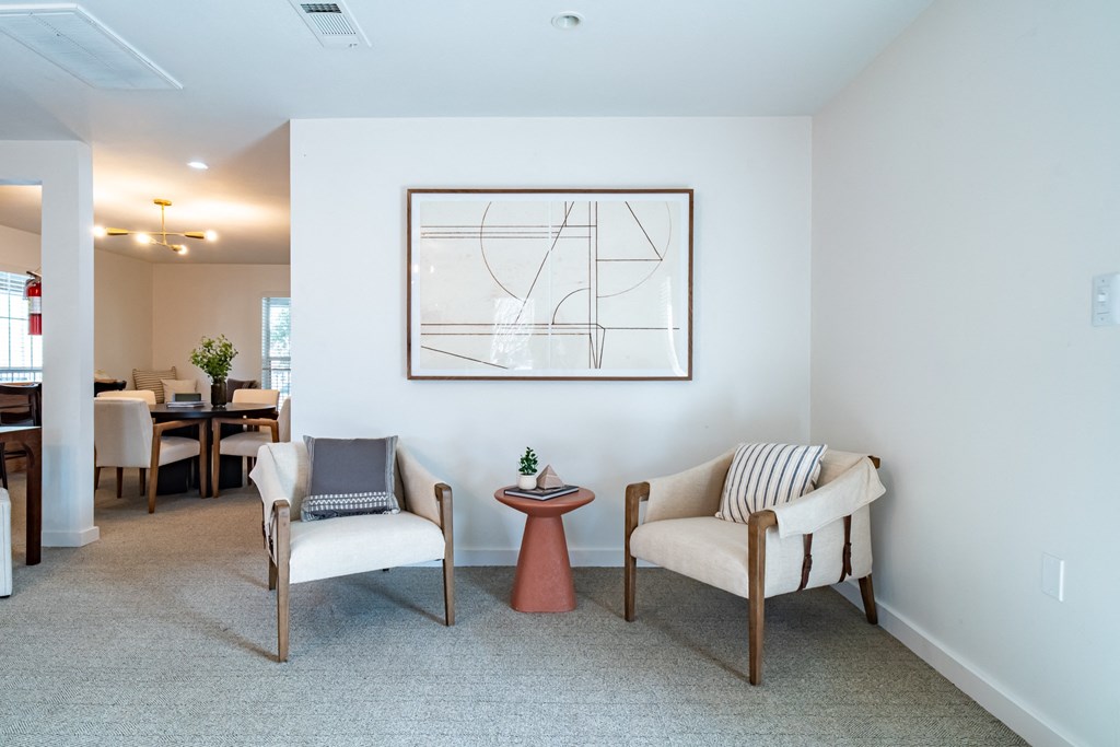 a living room with two chairs and a table