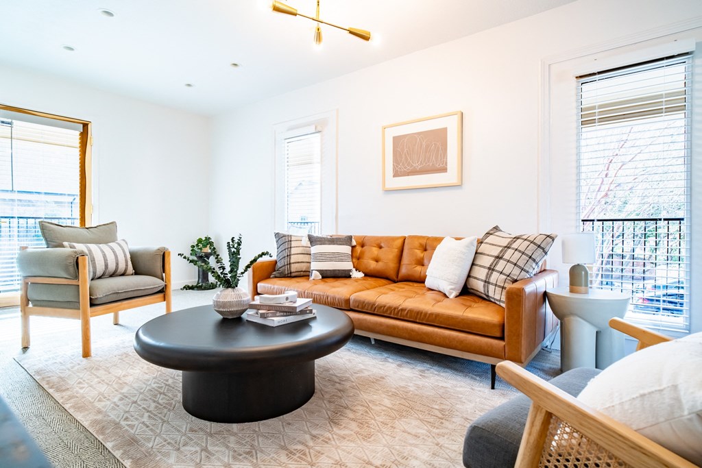 a living room with a leather couch and a coffee table