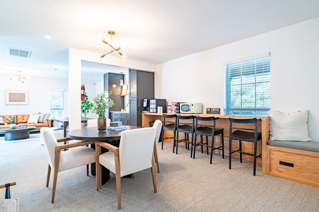 a living room and dining room with a table and chairs and a kitchen