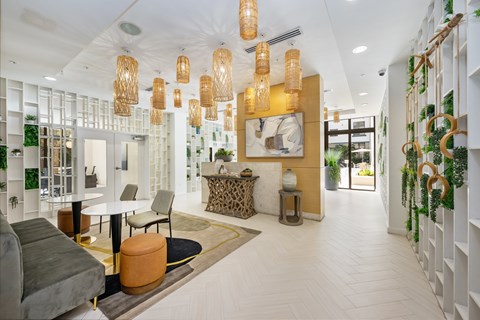 A modern living room with a grey sofa and a white coffee table.
