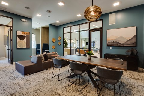 a dining room with a wooden table and chairs