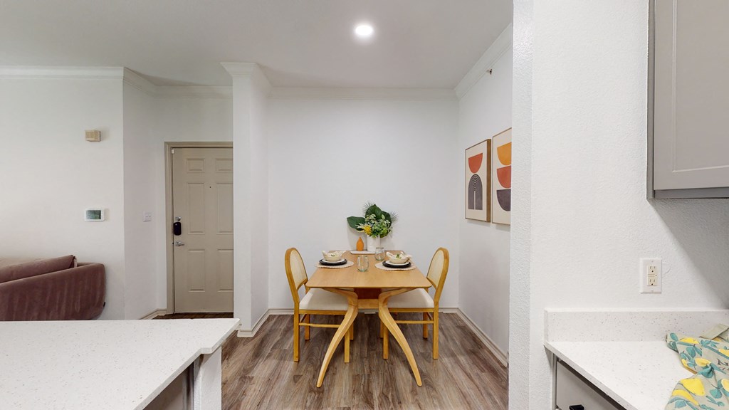 a dining room with a wooden table and chairs