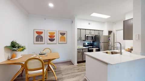 a kitchen and dining room with a table and chairs