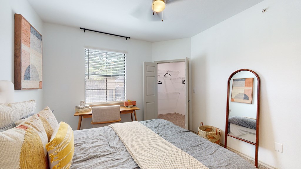 a bedroom with a bed and a mirror