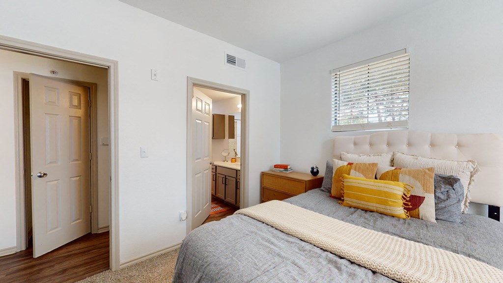 a bedroom with a bed and a bathroom