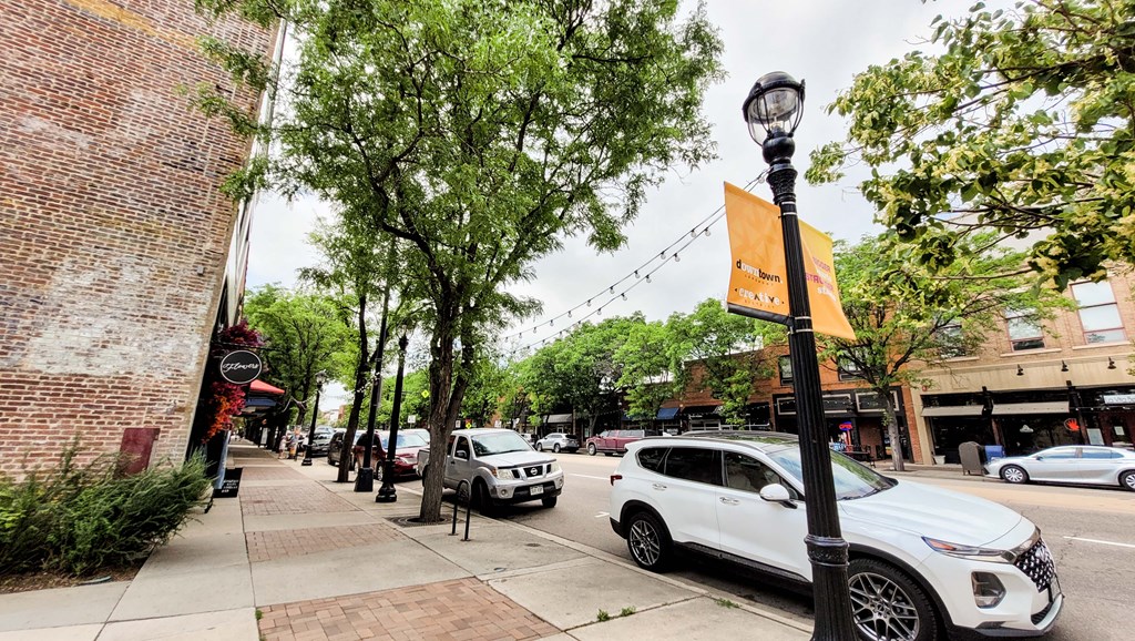 a city street with cars parked on the side of the road
