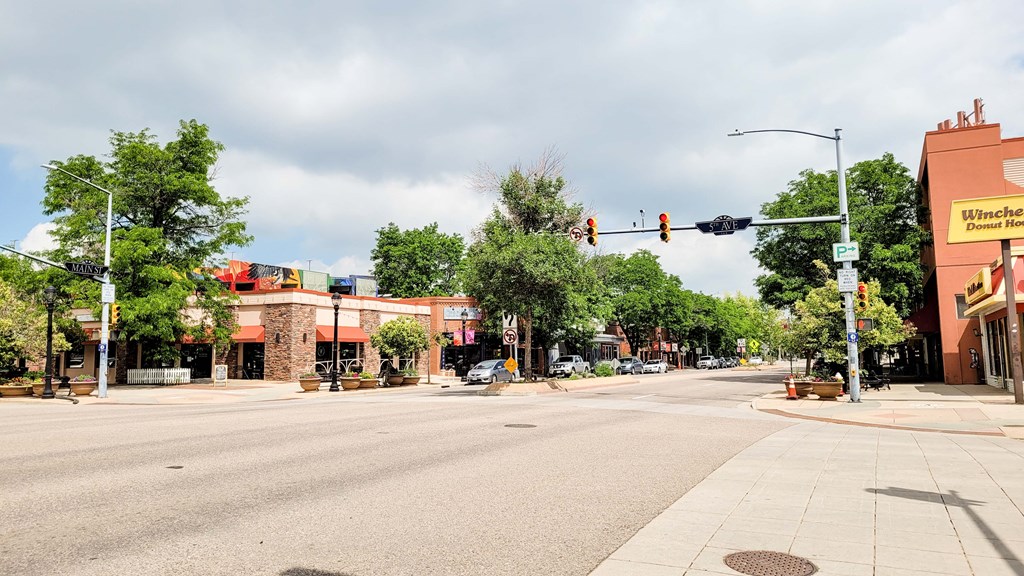an empty city street with a red traffic light