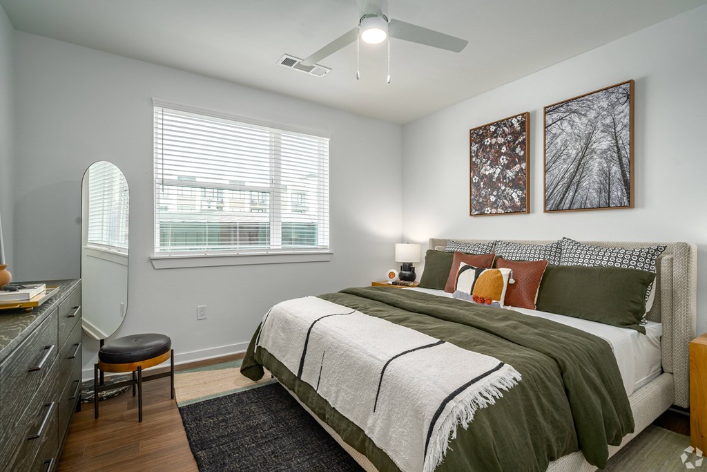 a bedroom with a bed and a ceiling fan