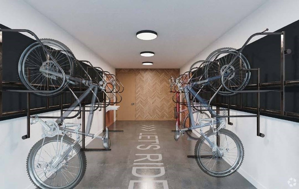 a room with two bikes hanging from the ceiling in a building