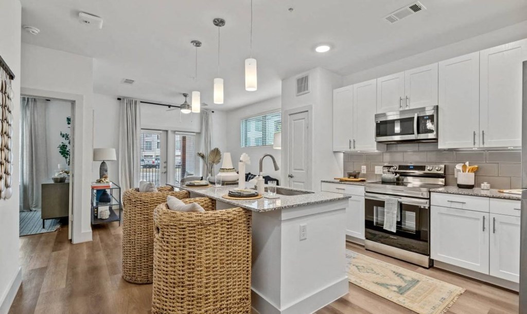 an open kitchen and living room with a table and chairs