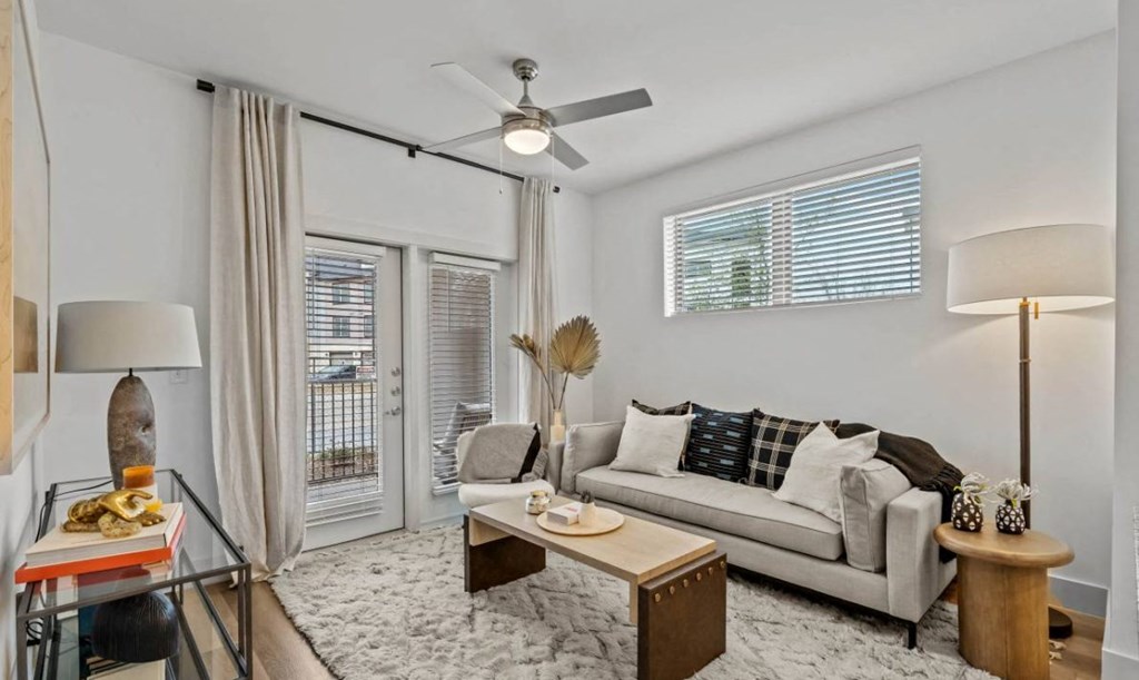 a living room with a couch and a ceiling fan