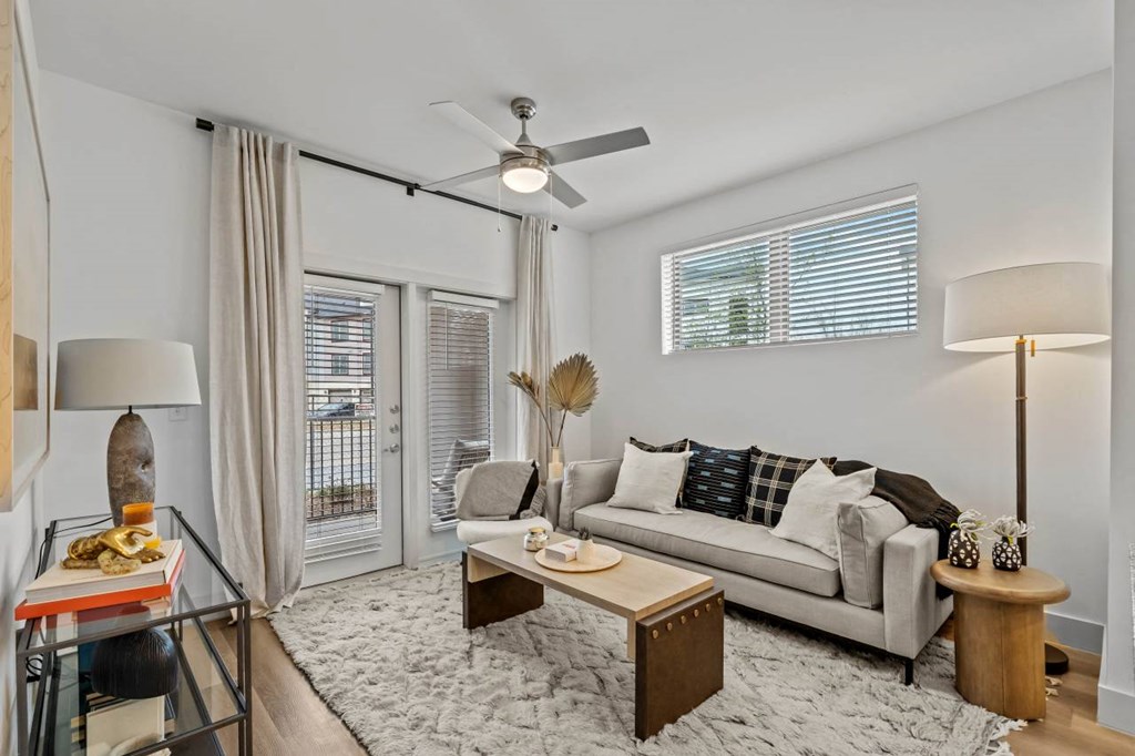 a living room with a couch and a ceiling fan