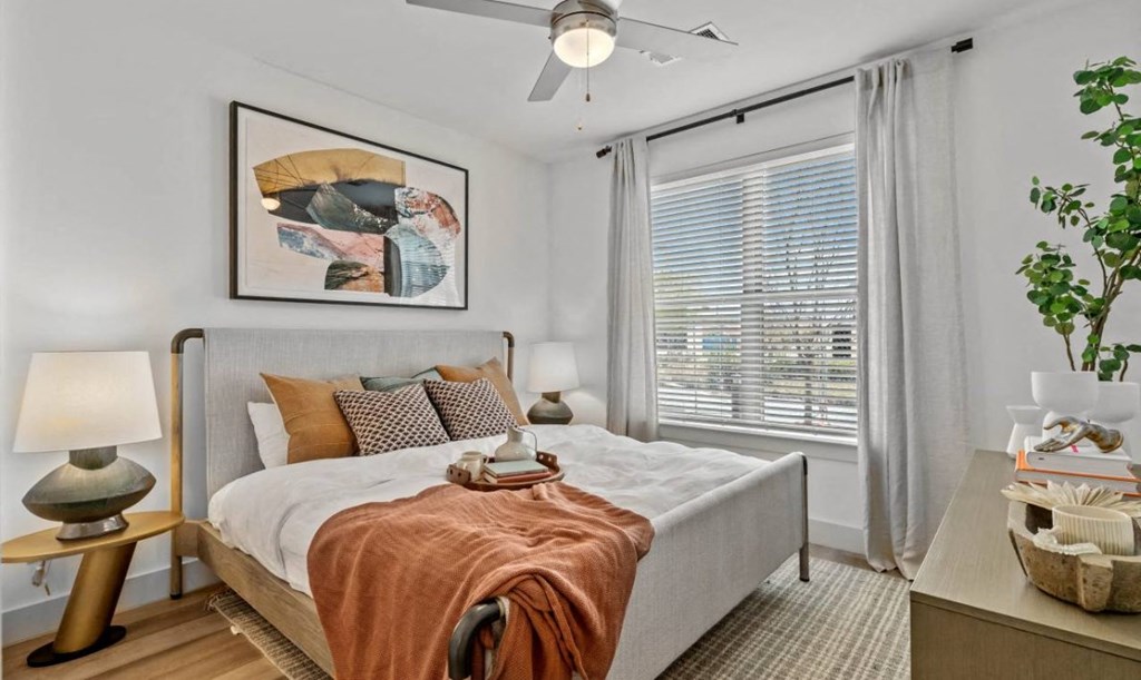 a bedroom with a bed and a large window