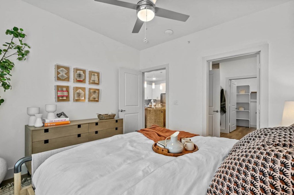 a bedroom with a bed and a ceiling fan